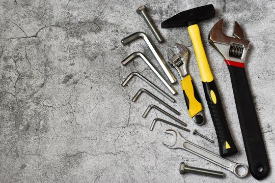 Father's Day Concept. Tools for repair and construction on gray concrete background. Copy space. Flat lay.