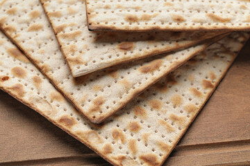 Jewish flatbread matza for Passover on wooden background, closeup