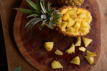 pineapple fruit split on a wooden table base