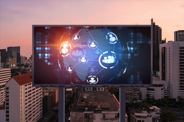 World planet Earth map hologram and social media icons on billboard over night panoramic city view of Bangkok, Southeast Asia. Networking and establishing new connections between people. Globe