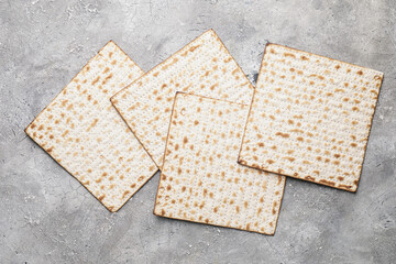 Jewish flatbread matza for Passover on grey background