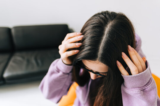 Young Brunette Woman Showing Her Scalp, Hair Roots, Color, Grey Hair, Hair Loss Or Dry Scalp Problem.