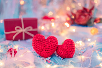heart shape, Foam beads, feather, gift box and light decorative bokeh on blue cloth. Love, Valentine and holiday concept.