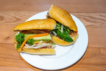Vietnamese cuisine - banh mi, baguette stuffed with pork and vegetables