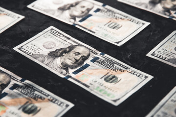 One hundred dollar bills are creatively laid out. Business concept, development perspective.