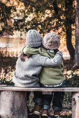 Two happy girls as friends hug each other. Little girlfriends in park. Children Friendship.