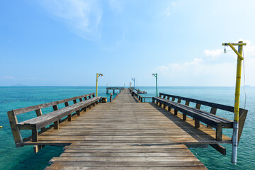 Fototapeta premium Long wooden bridge go to the sea in beautiful tropical island, Thailand.