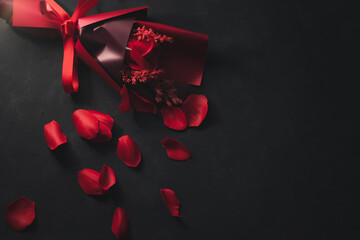 A bouquet of beautiful bright red wooden rose petals placed on a black background. Valentine's Day,...