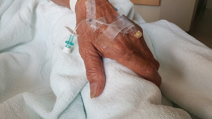 Close up the old patient hand in the hospital.