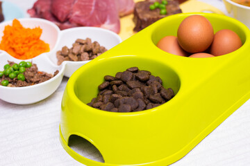 Preparing natural organic food for pets at home. Raw ingredients for pet food in bowl