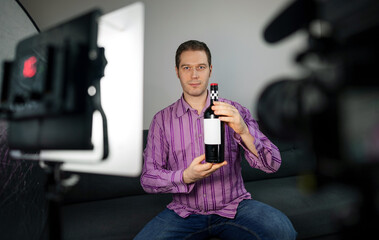 Man making video blog about wine and alcohol.