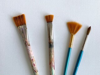 Brushes and clear canvas on the white table.  Artist, art and hobby. Drawing and painting. 