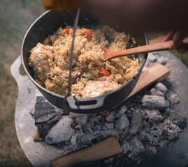 Biryani with chicken and vegetables in iron pot, it’s a popular Indian and Pakistani food.