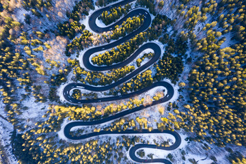 Aerial drone photograph bird's eye perspective of a beautiful winding mountain road in Romania in...