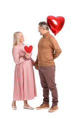 Mature couple with heart and balloon on white background. Valentine's Day celebration