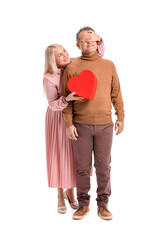 Mature couple with gift on white background. Valentine's Day celebration