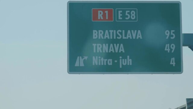 Traffic sign on highway with Bratislava and Trnava in Slovakia, passing by