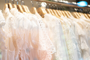 A few beautiful white dresses on a hanger