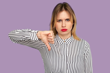 Dislike! Attractive blond woman with bright red lips frowning with naughty expression and showing...