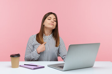 This is me! Self confident egoistic business woman pointing herself and looking at laptop display...