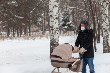 Father pushing baby stroller and walking at park in blizzard.
