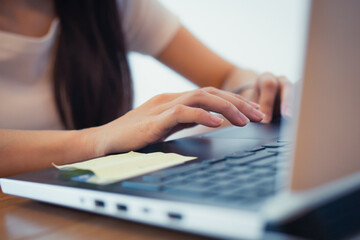 Close up hand of business people, student, adult typing text, email and searching information while sitting at home, workplace. Working on laptop computer concept.