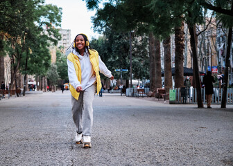 Woman listening music while roller skating. © alvaro