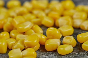 A heap of boiled sweet corn on a marble background
