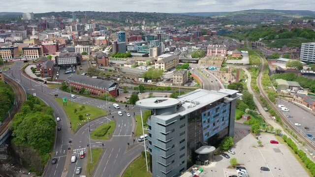 Aerial footage of the city centre of Sheffield in South Yorkshire in the UK showing the Capita Employee Benefits building in the city centre on a sunny summers day