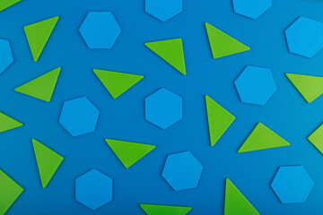 Abstract geometric background with green triangles and blue polygons on blue background