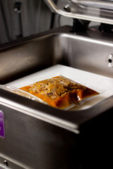 Cochinita pibil, pork, in vacuum packaging. Use of the vacuum sealing machine for food packaging.