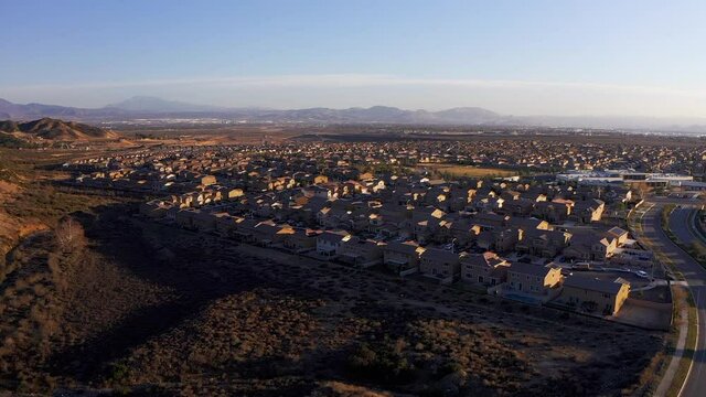 Aerial reverse pull-back shot of a master-planned community in the desert. HD at 60 FPS.