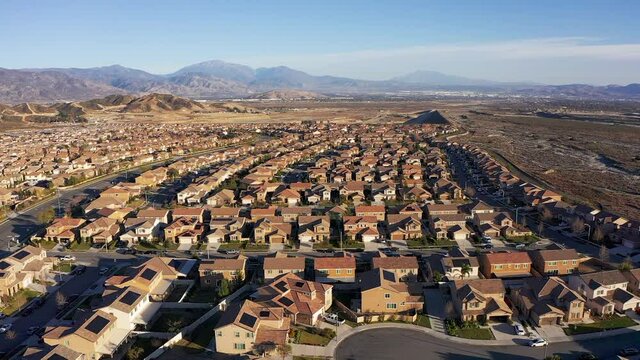 Wide aerial descending shot of a desert master-planned community development. HD at 60 FPS.