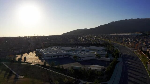 Wide aerial shot of a school in a master-planned development in the desert. HD at 60 FPS.