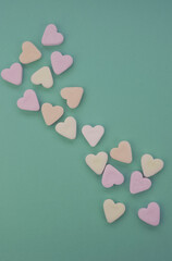hearts shaped candy on green background