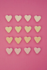 Fototapeta premium colored sweet hearts for valentine pink red background