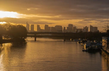 Fototapeta premium Paris, France - 01 17 2021: View of the Seine and The Defense district at sunset from Clichy Bridge