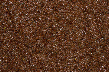 Flax seeds in full screen. Selected flax seeds. Spread for baking.
