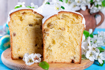 Traditional easter cake kulich Ukrainian Russian style with colored eggs on blue background