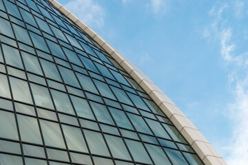 Fototapeta na wymiar Fragment of a glass office building against a blue sky