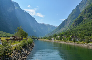 Majestic landscape vith houses, river and mountain norwegian fjords at viking village Gudvangen, Naeroyfjord, Norway
