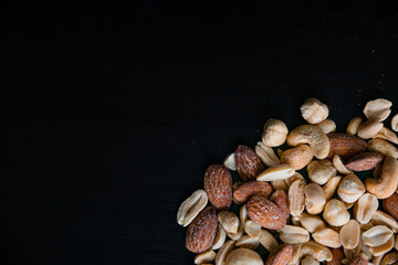 Fototapeta na wymiar Amount of nuts on a black background