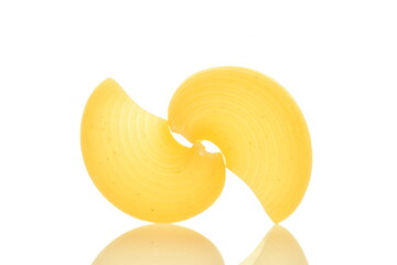 Bright yellow uncooked pasta, close-up, isolated on white.