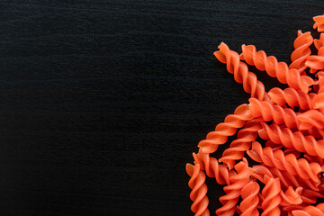 Red lentil pasta on a black background