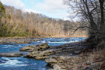 Fototapeta na wymiar Beautiful look at the Youghiogheny River as it flows through the Ohiopyle State Park on a very brisk winter morning.