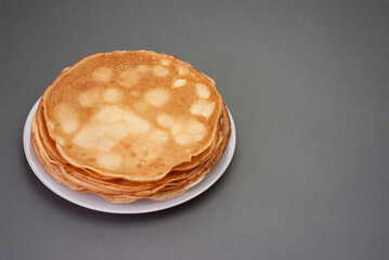 Cooking pancakes. Shrovetide (Maslenitsa) - blini stack on a white plate