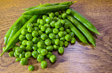 Fresh Green Peas On Wood Background