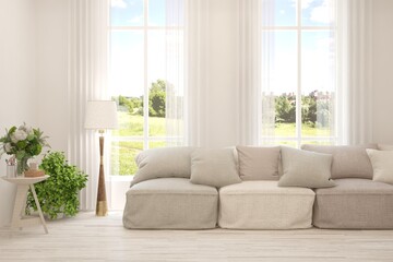 White living room with sofa and summer landscape in window. Scandinavian interior design. 3D illustration