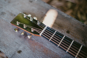 Wooden guitar. Close-up of guitar lying on vintage wood background