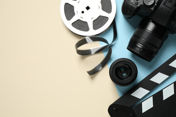 Flat lay composition with camera and video production equipment on color background. Space for text